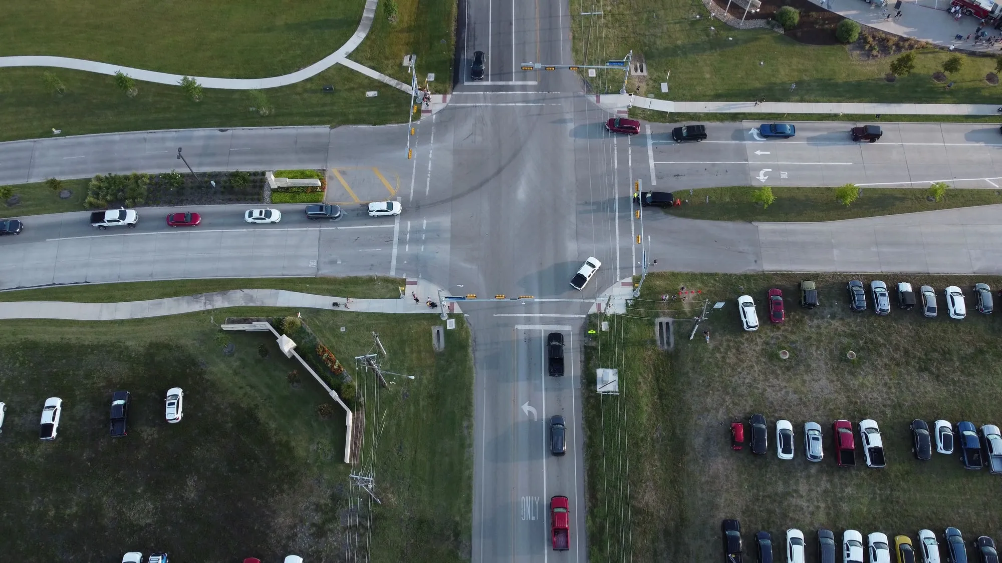 An overhead view of vehicles approaching a signal-controlled intersection.